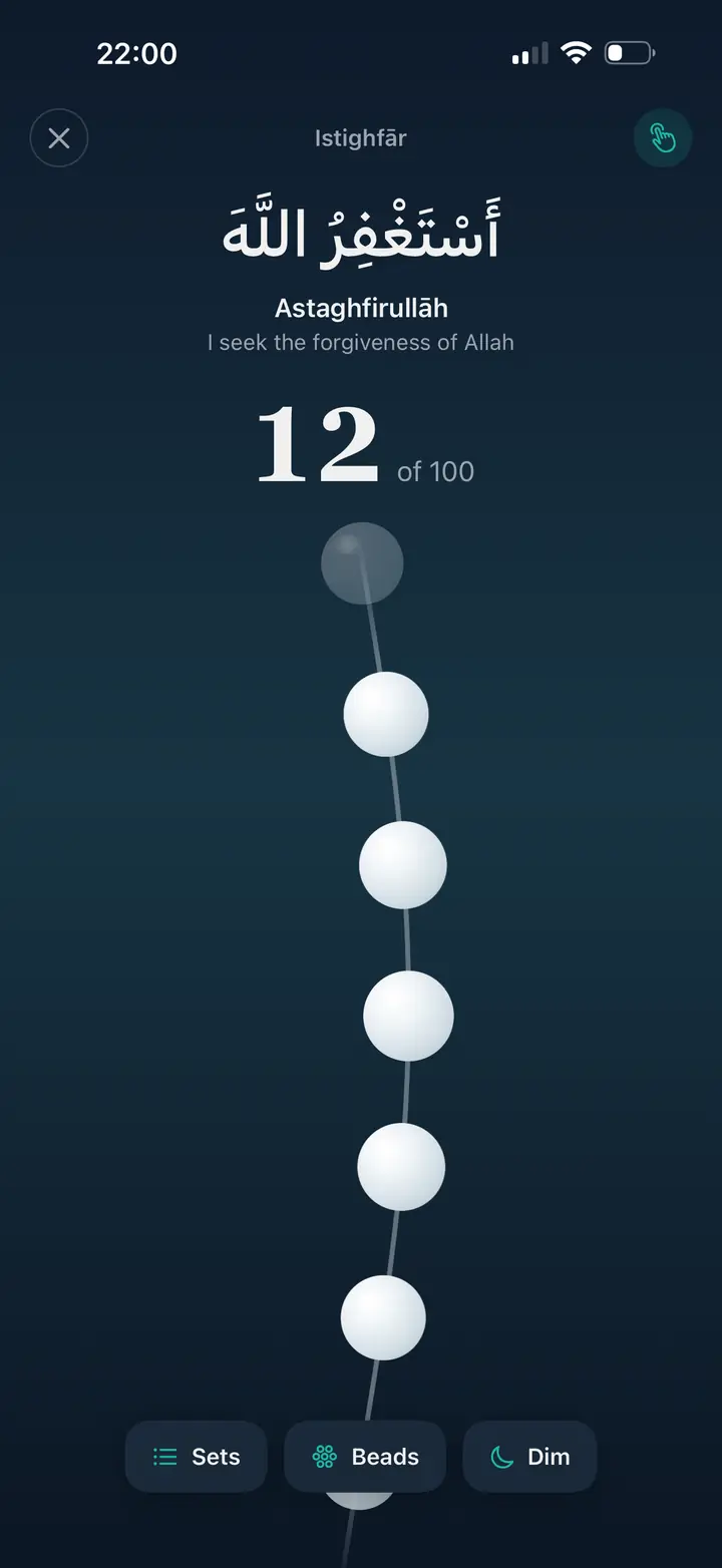 Misbaha digital tasbih counting Istighfar, 12 of 100, with a strand of beads